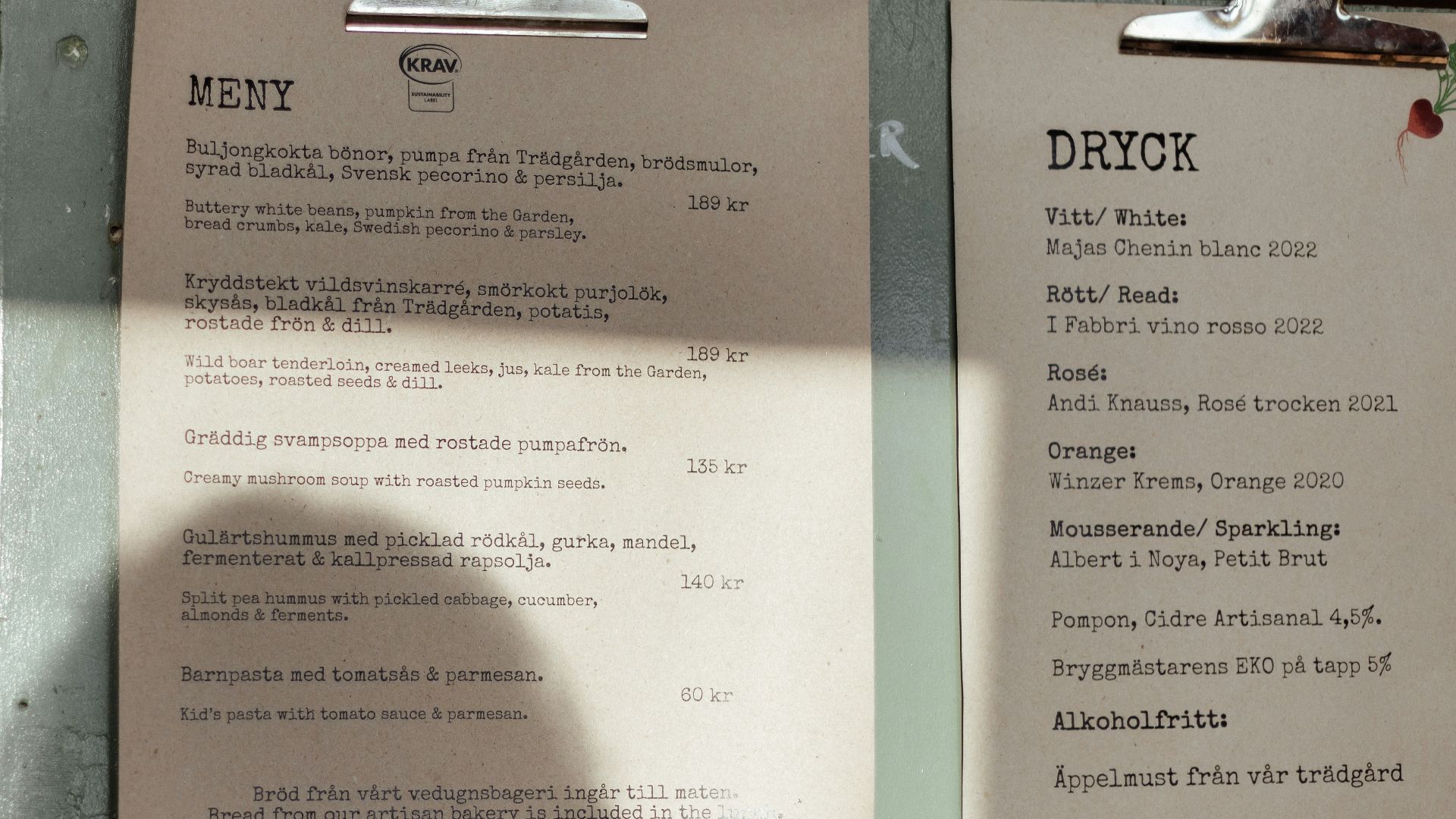 A menu sitting on top of a table next to a cup of coffee