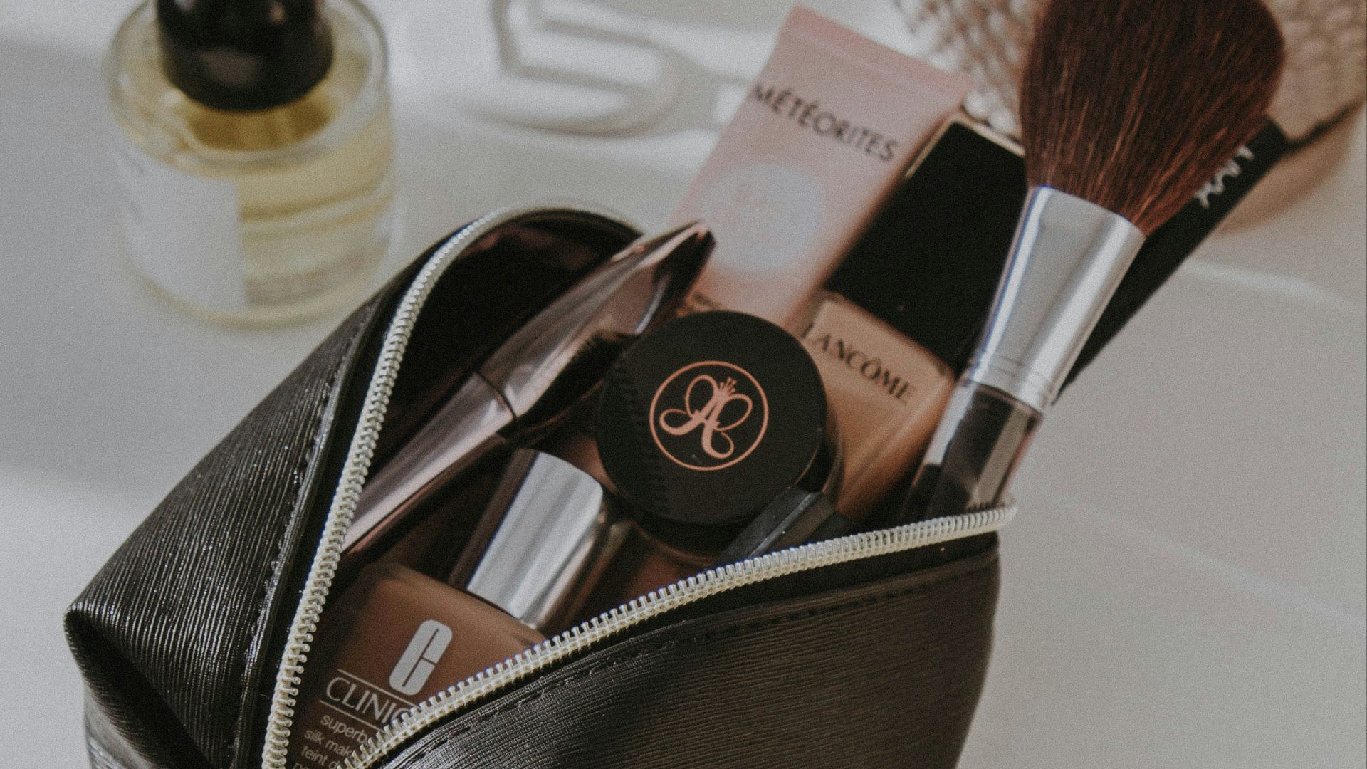 black leather bag with makeup brushes and makeup brushes