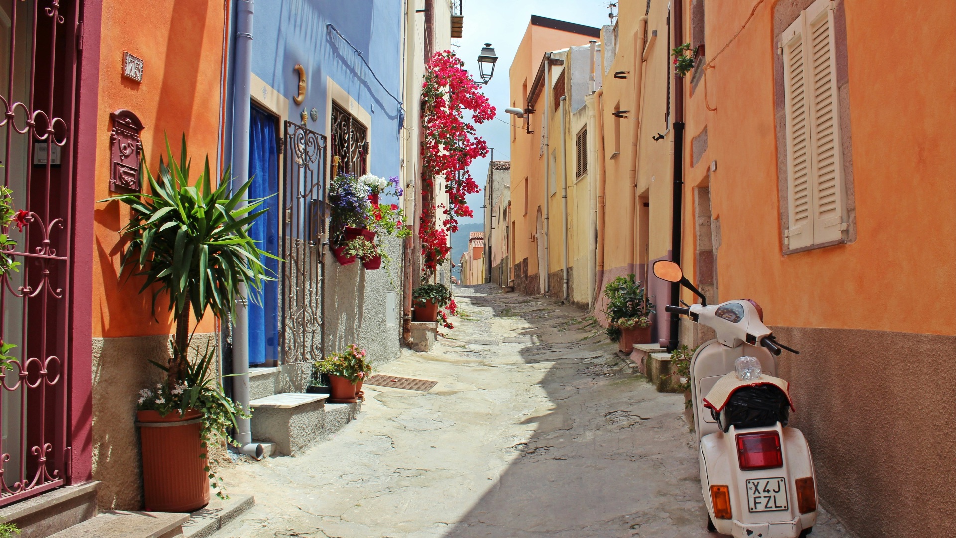 white motor scooter near building