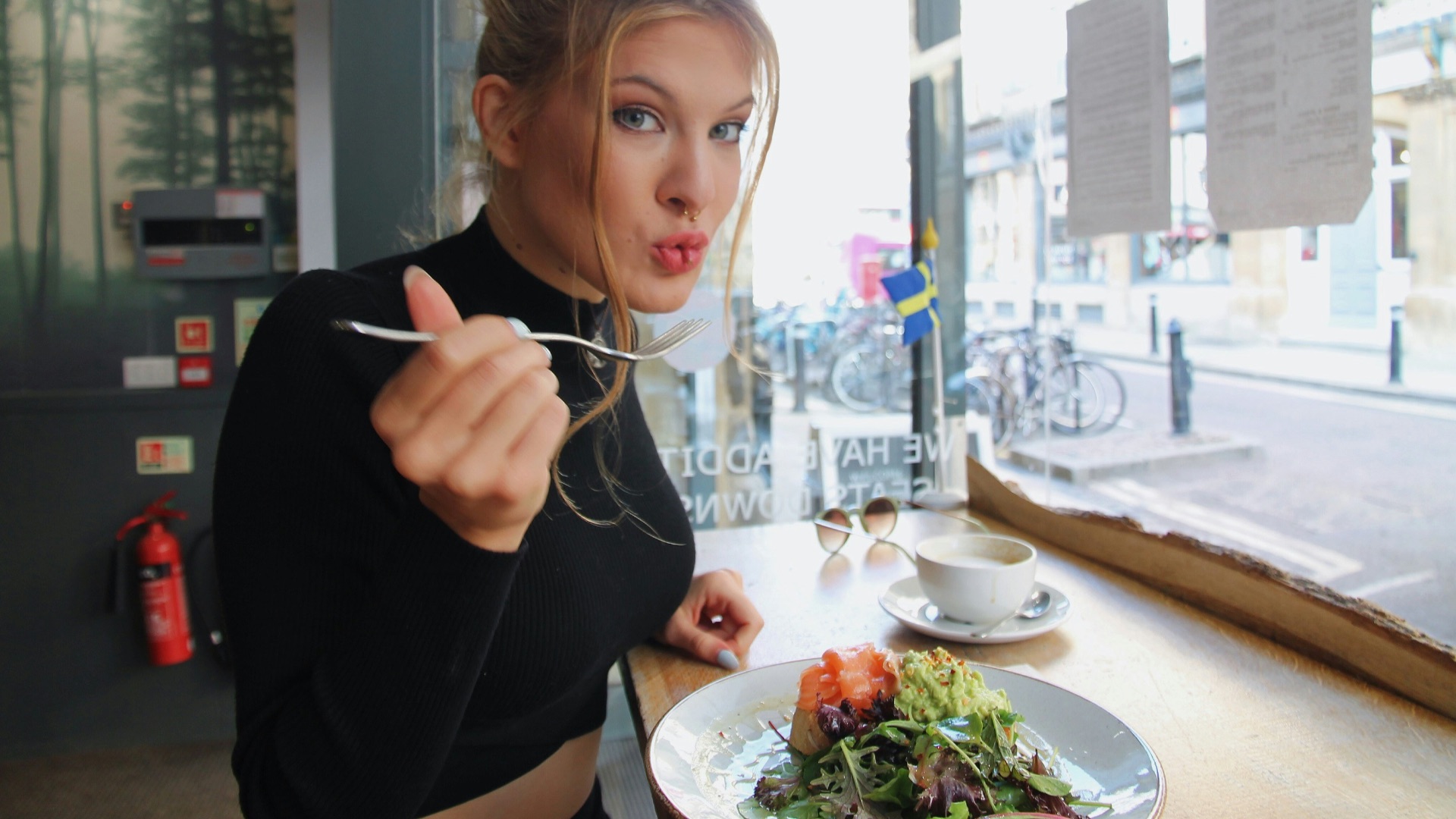 woman in black long sleeve shirt eating
