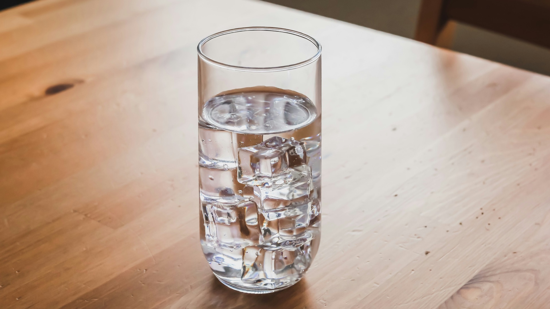 clear drinking glass on brown wooden table