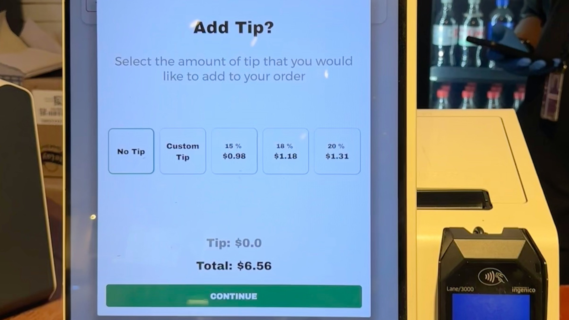 A checkout counter with a cell phone on it