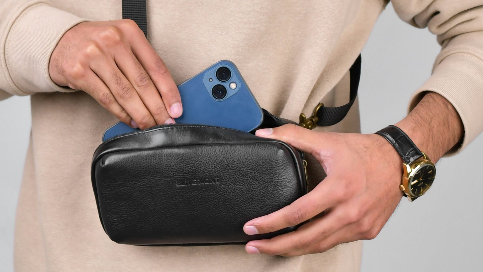 a man holding a black case with a blue phone in it