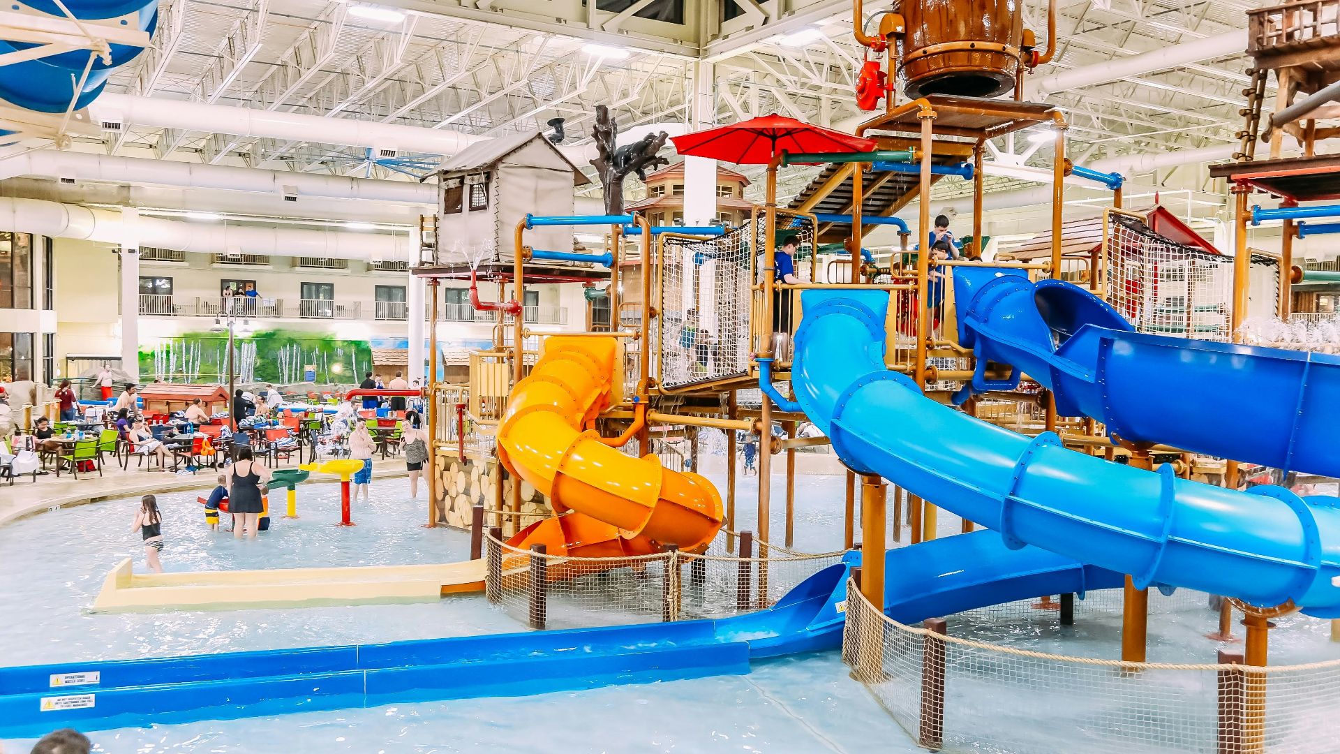 a large indoor water park with a water slide