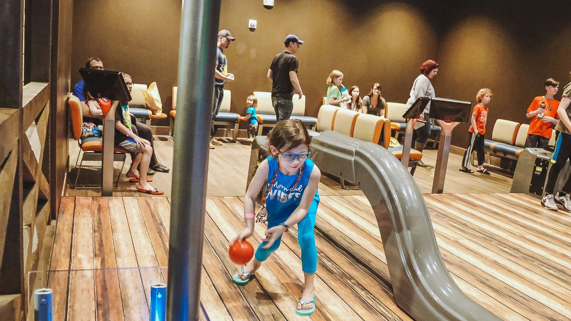 a group of children playing basketball on a wooden floor