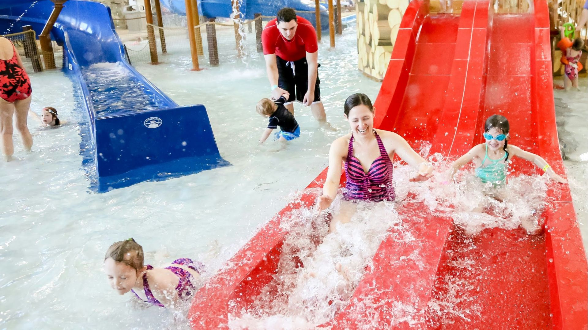 a group of children playing in a water park