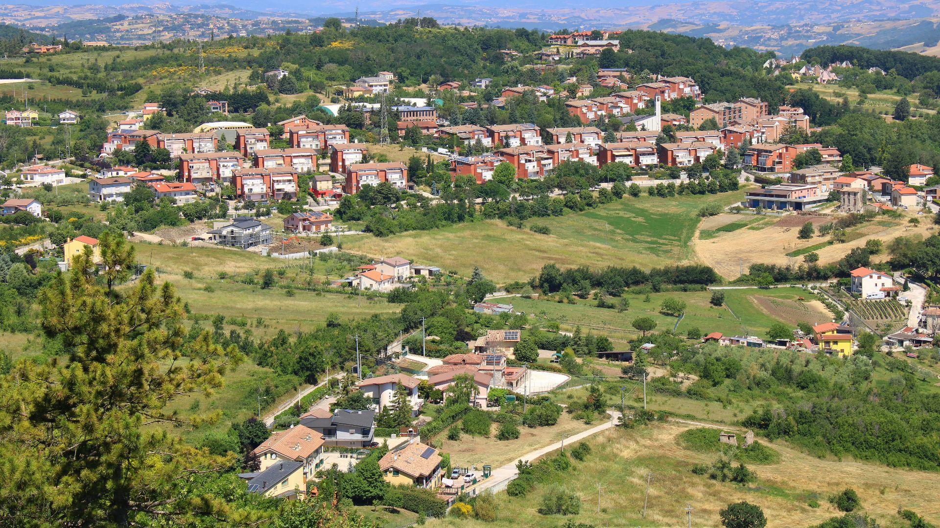 A small town nestled in a valley surrounded by trees