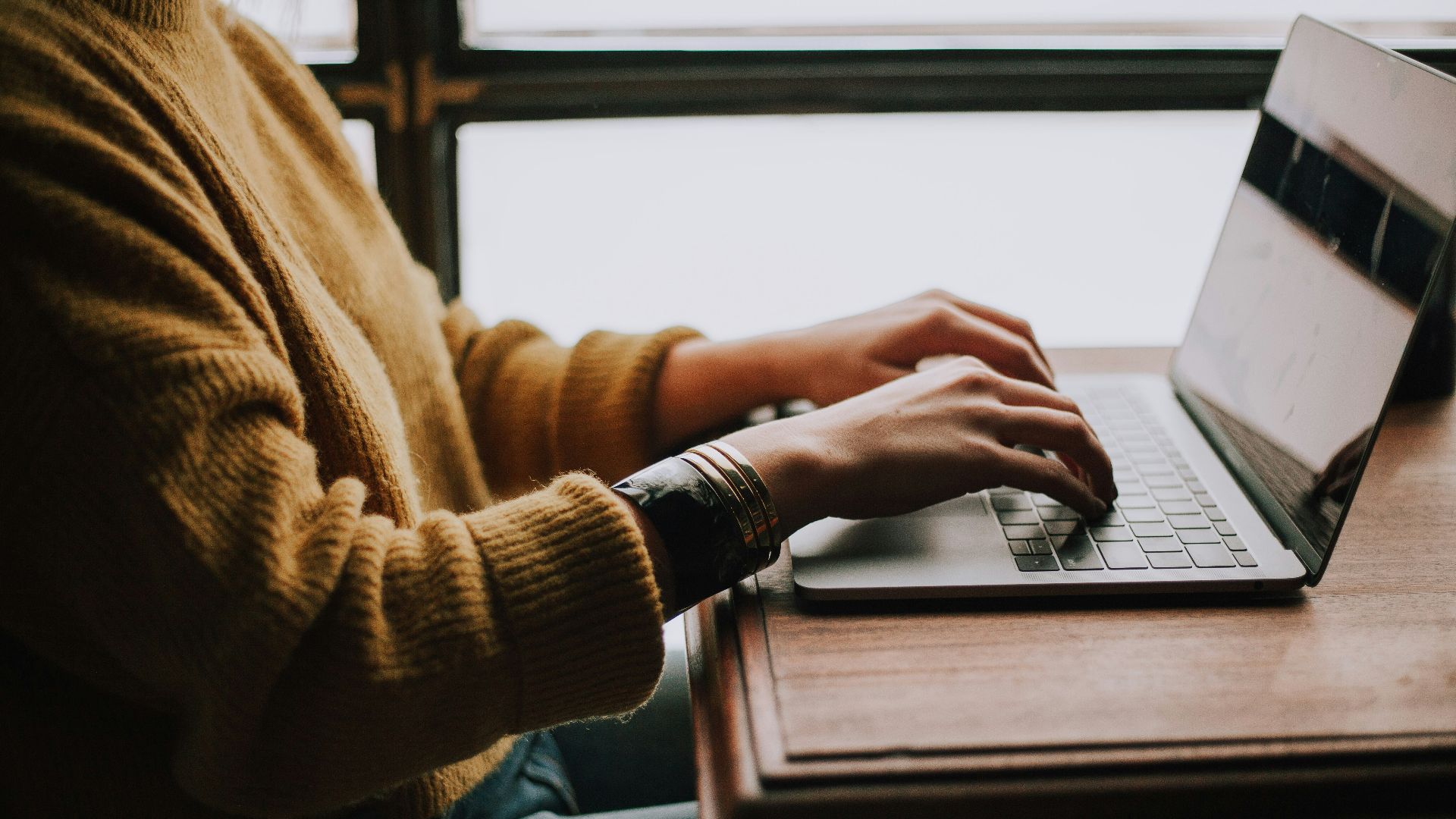 person sitting front of laptop