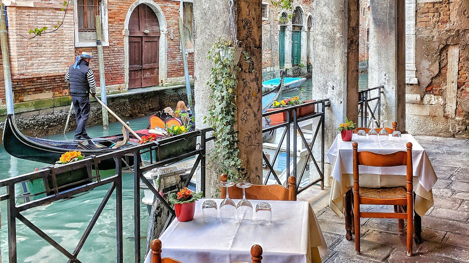 man riding on boat beside restaurant