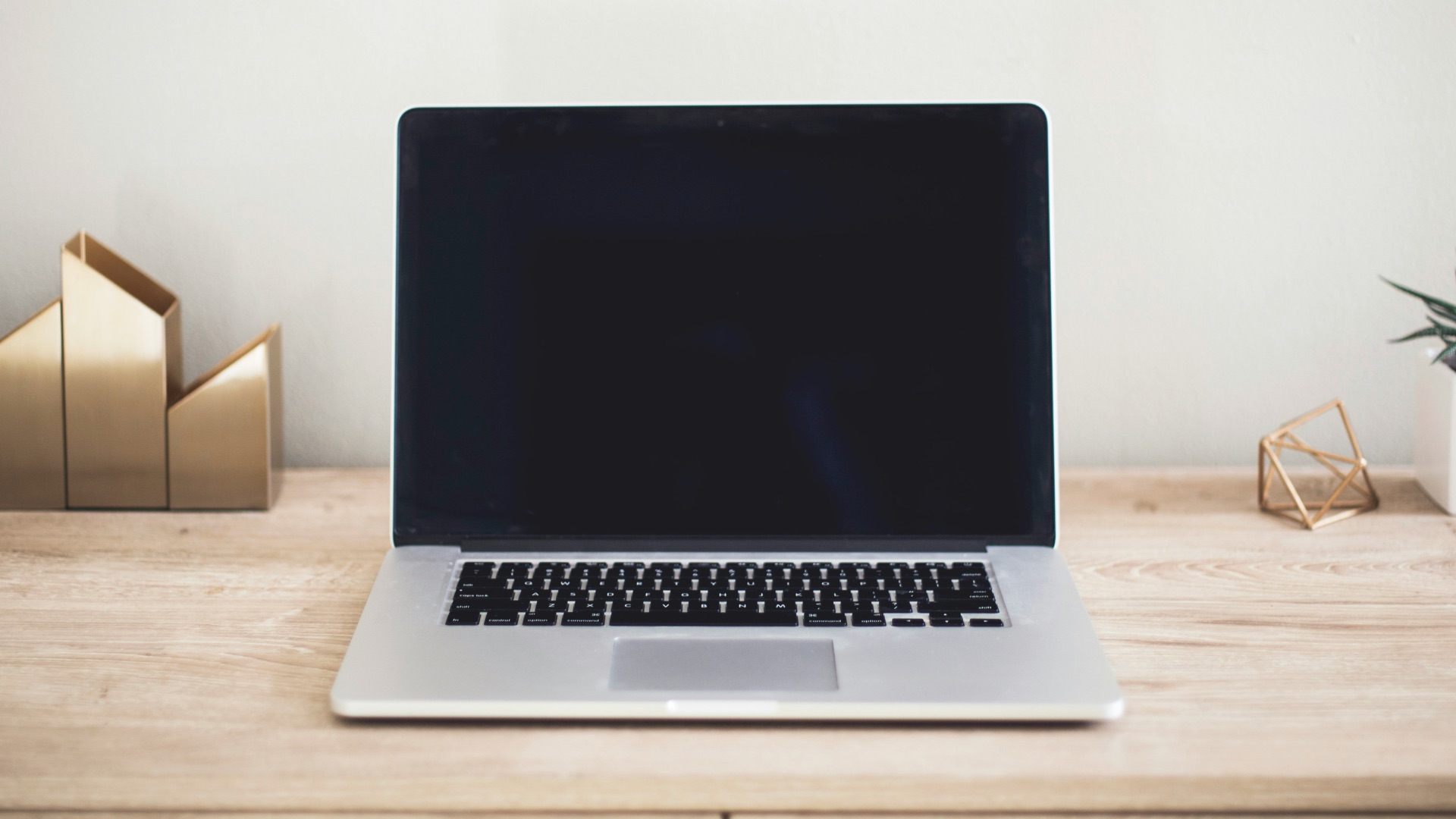 MacBook Pro on top of brown table