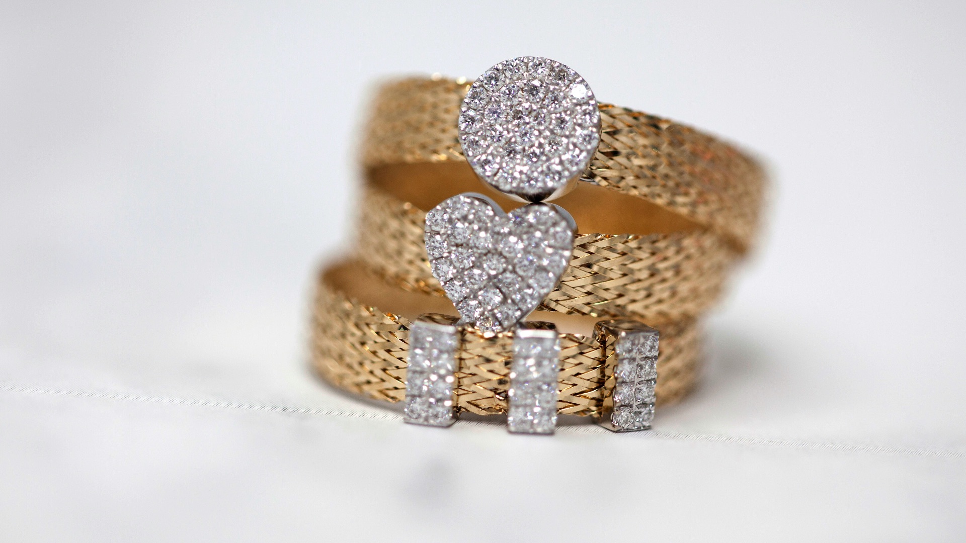 three gold-colored studded rings