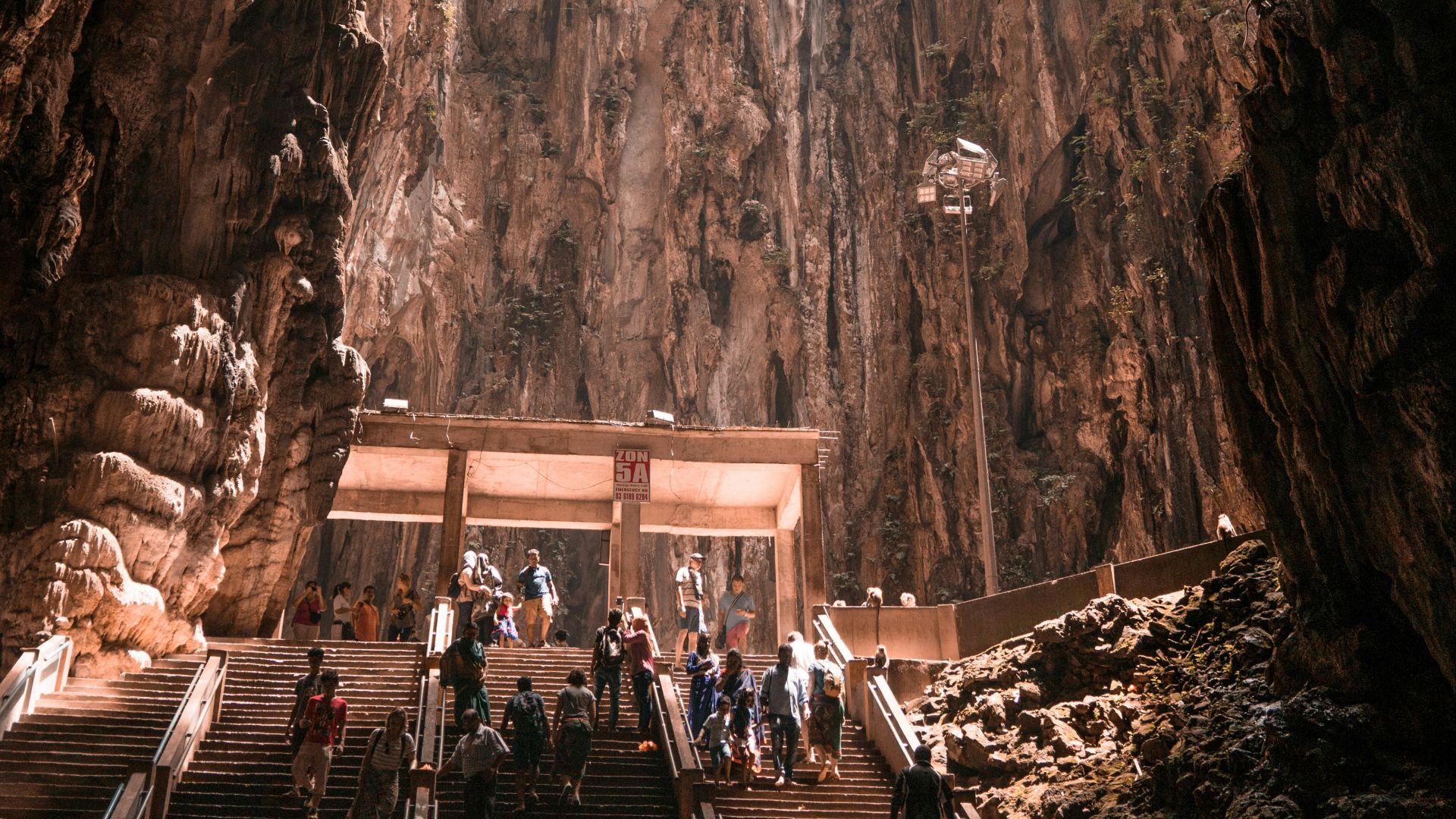 people at the stairs inside cave