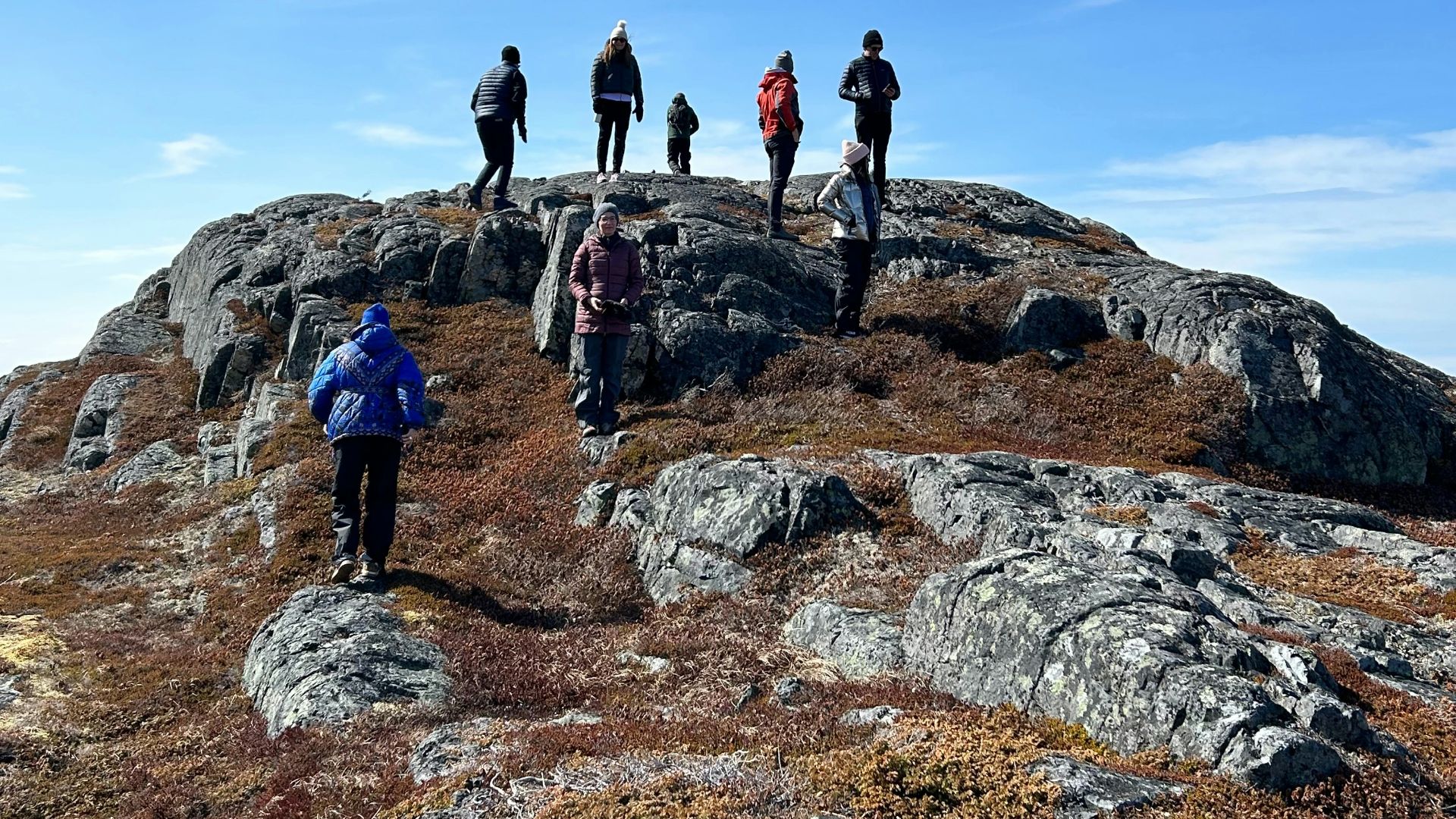 A group of people standing on top of a mountain