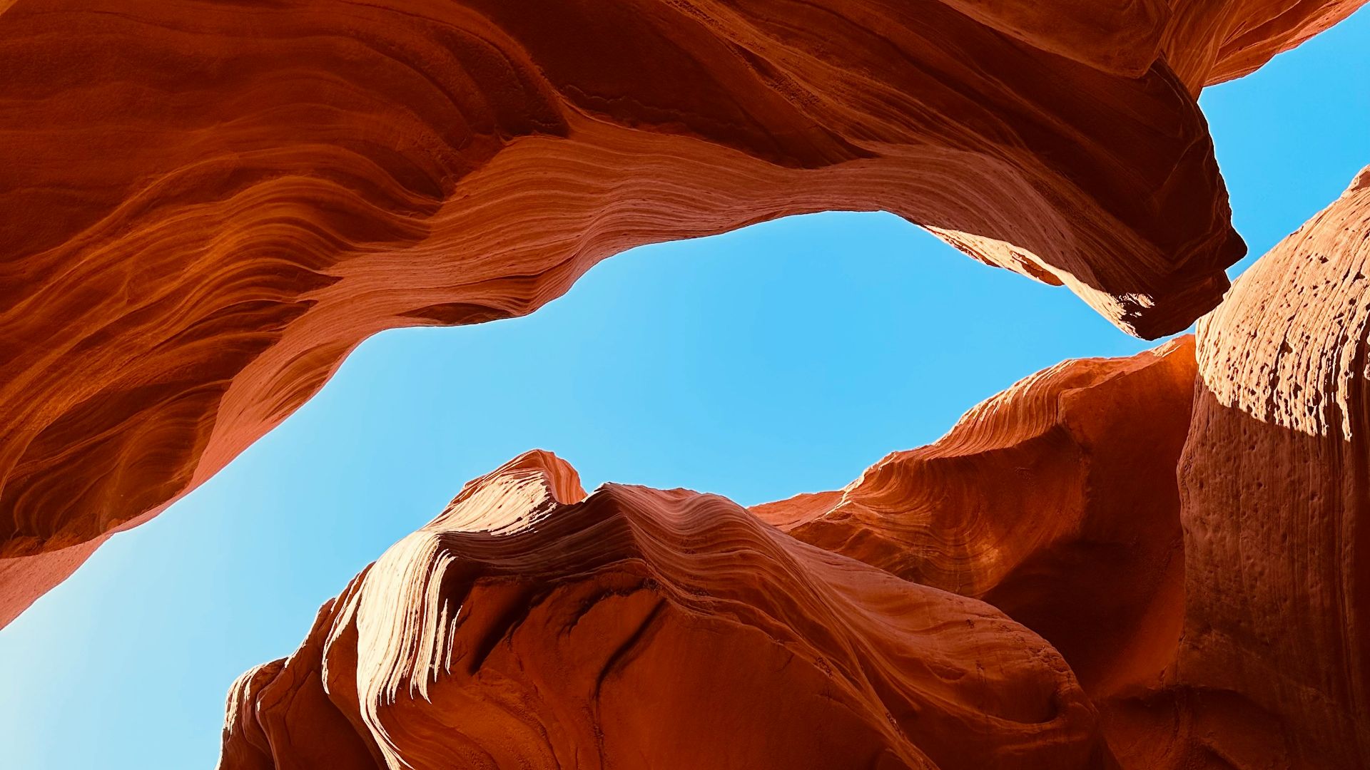 a large rock formation with a sky in the background