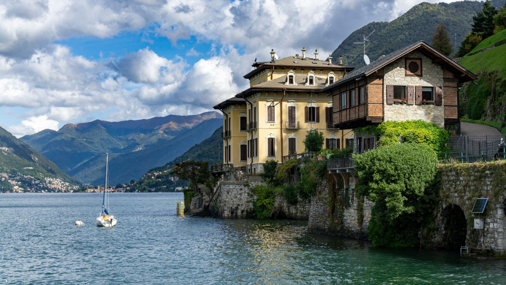 white boat on body of water near brown concrete building during daytime