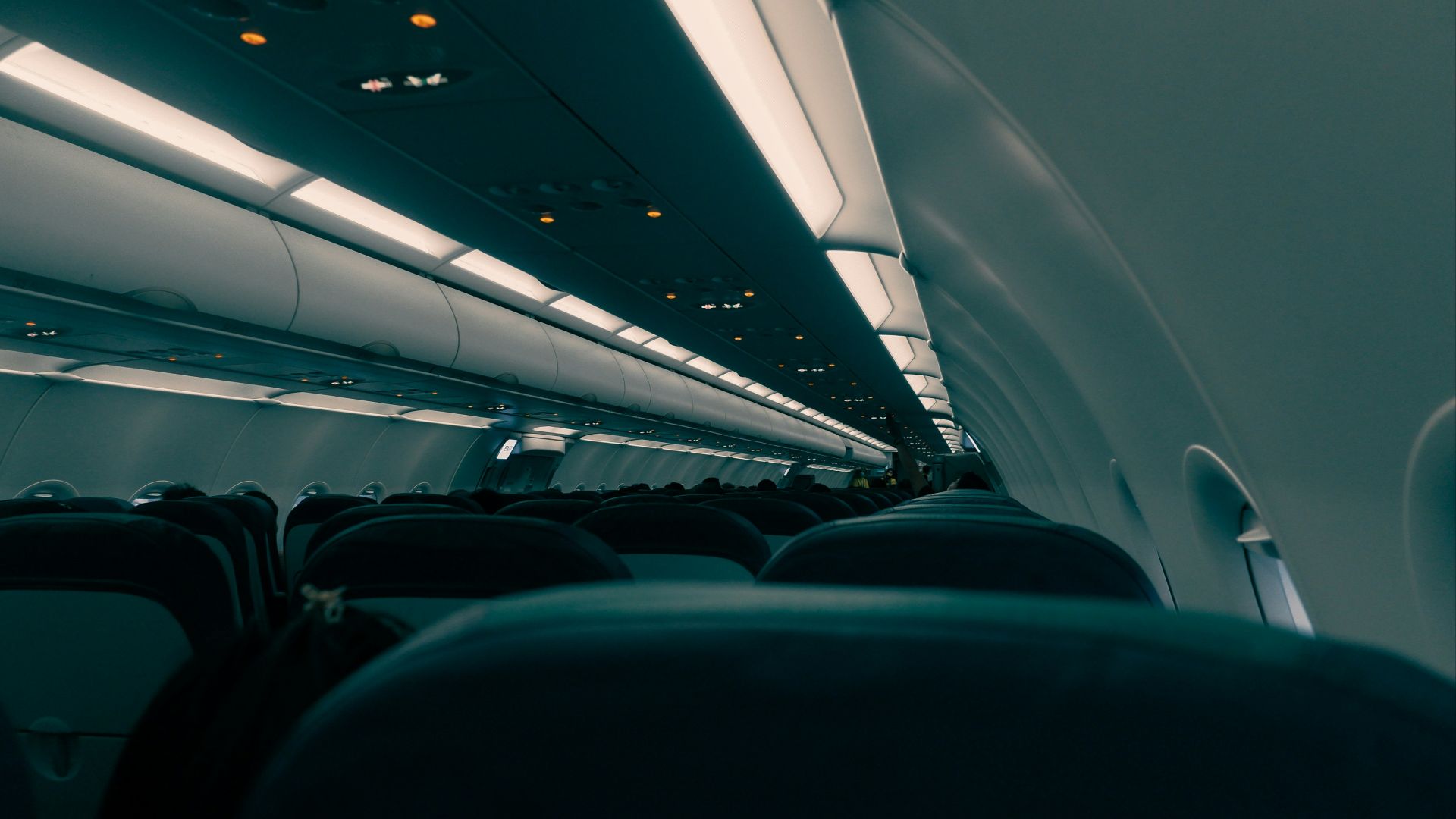 the inside of an airplane with the lights on