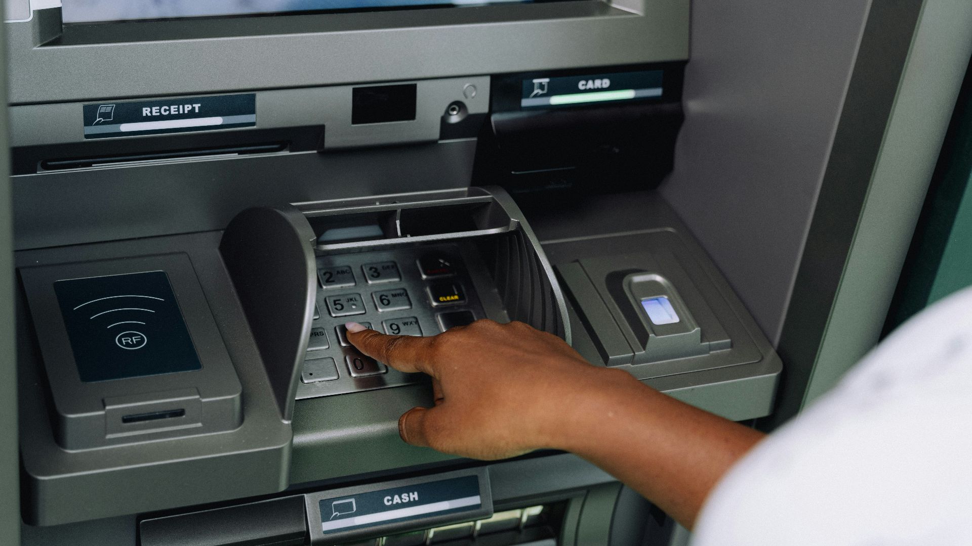 a person using an atm machine to pay money