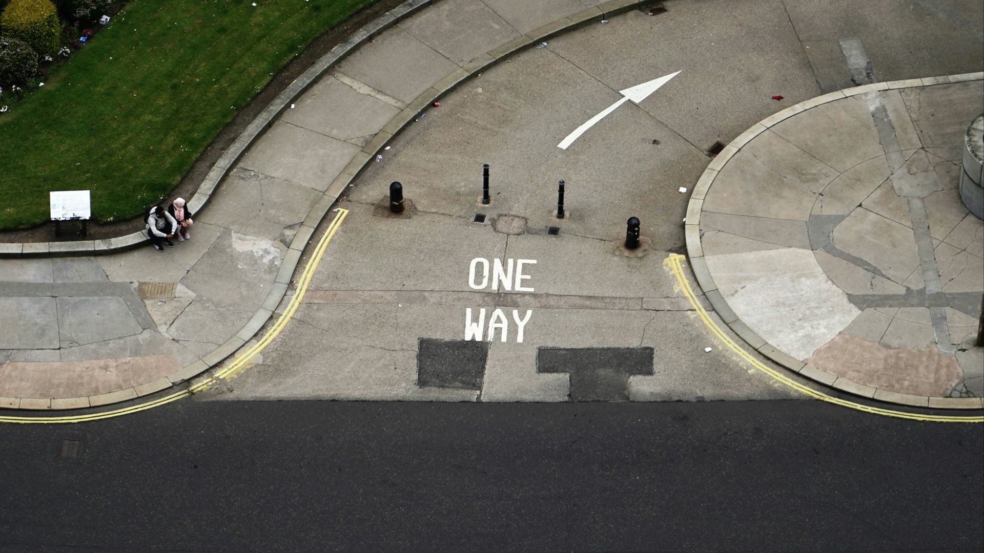 An aerial view of an intersection with a one way sign