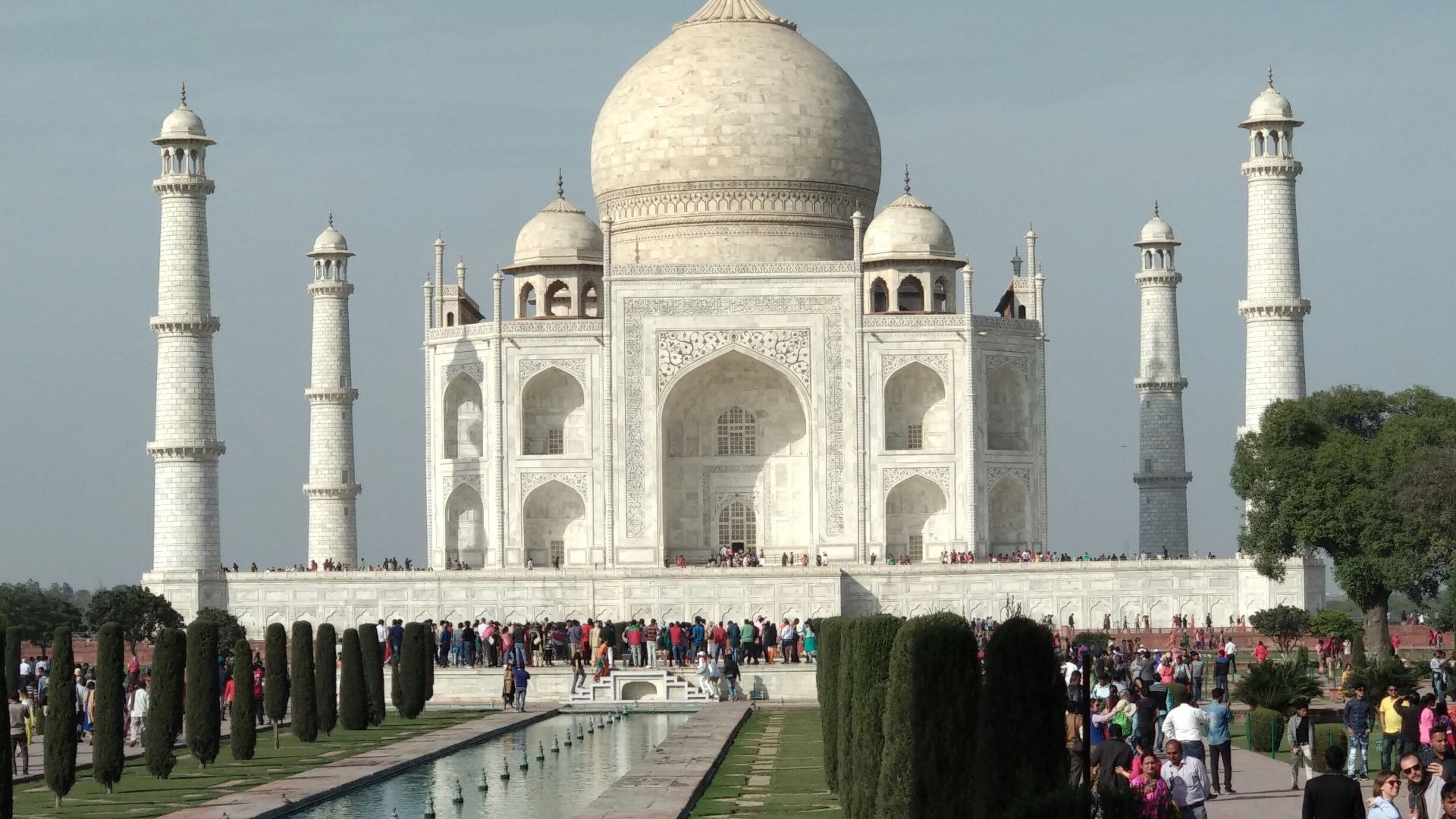 people walking on white concrete building during daytime