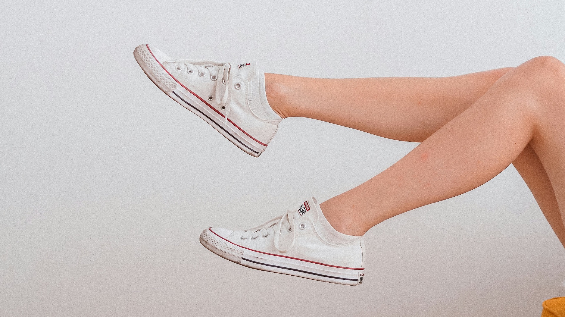 woman in white low top sneakers