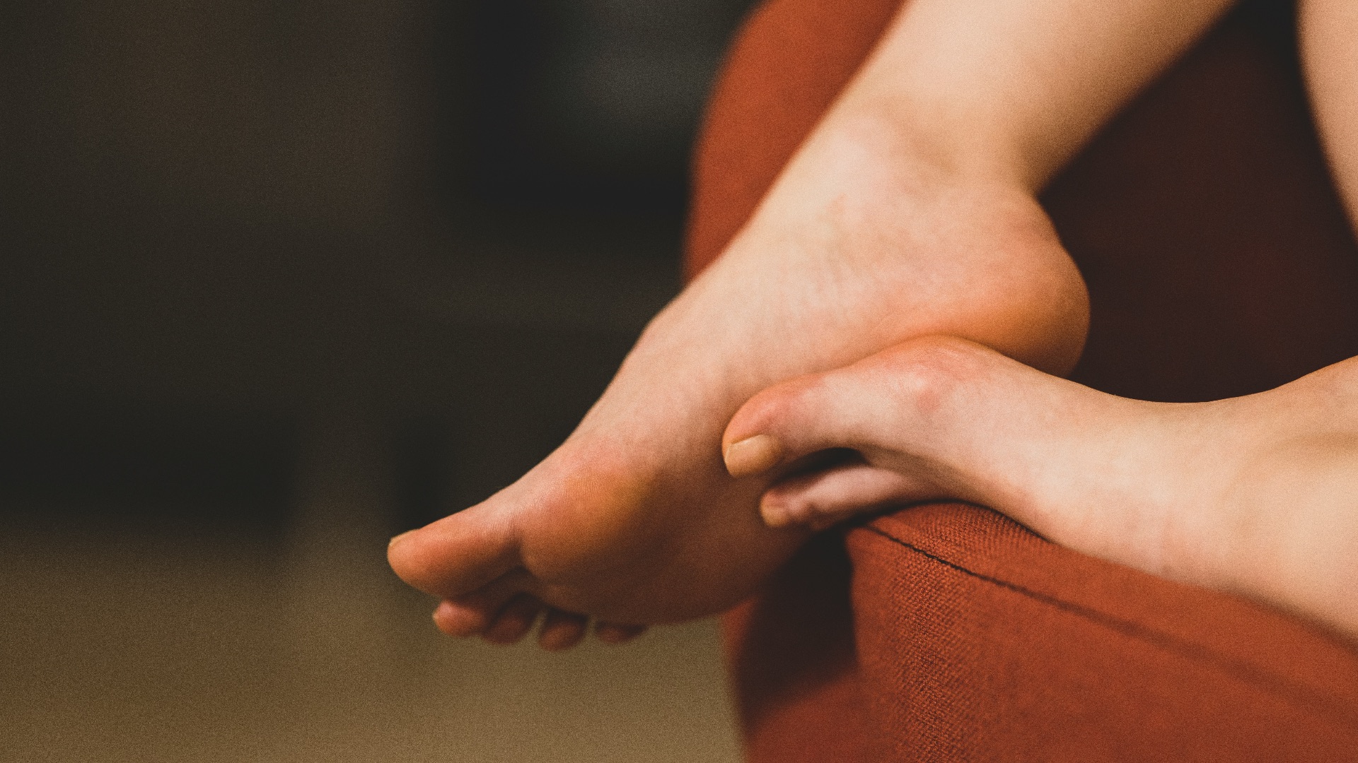 persons feet on brown textile