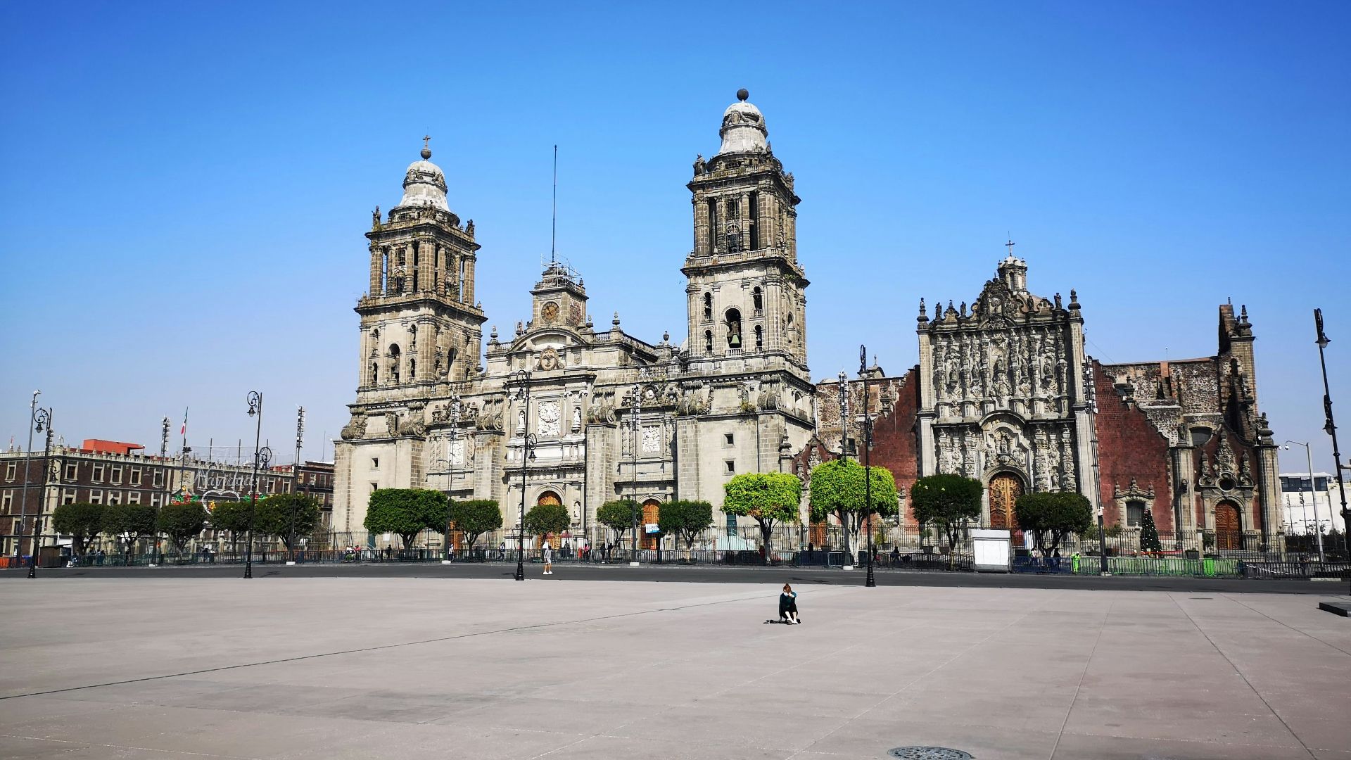 people walking on sidewalk near white concrete building during daytime