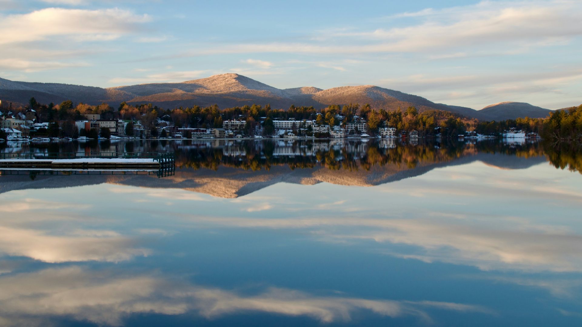 A body of water with mountains in the background
