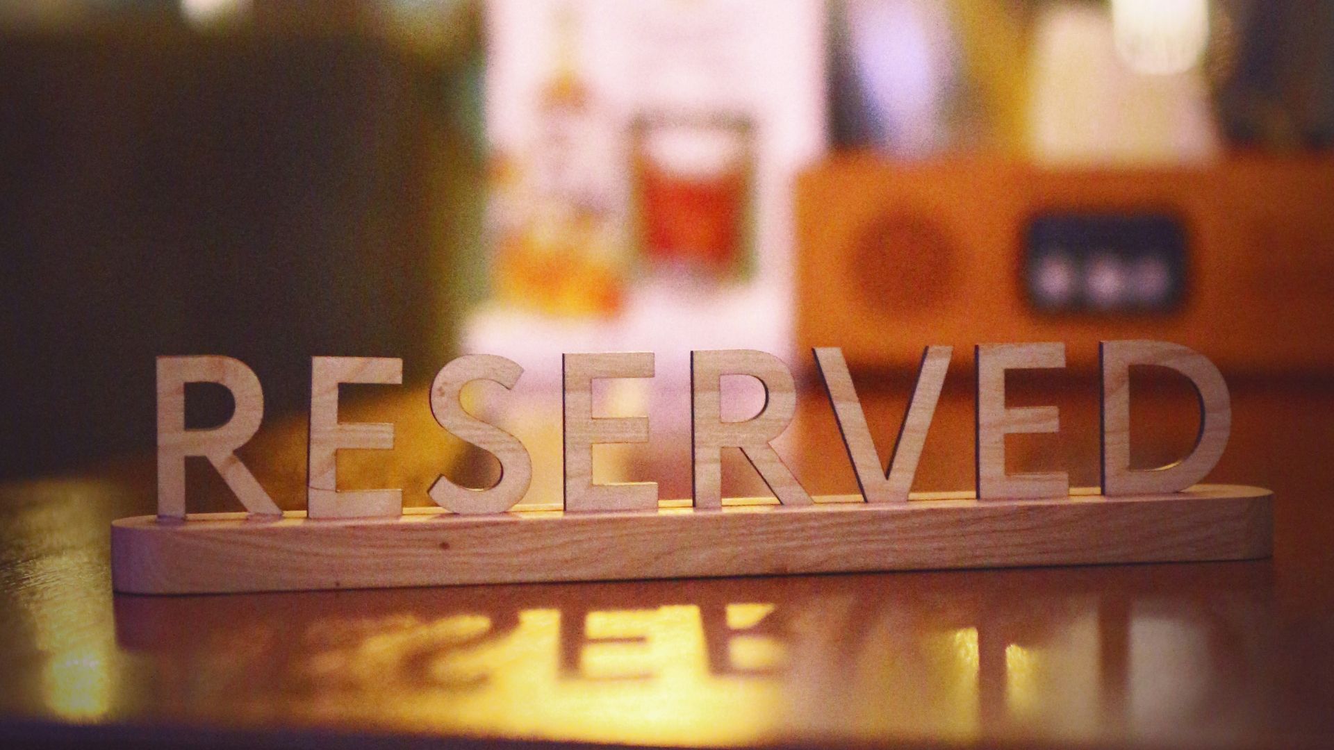 a wooden block that says reserved sitting on a table
