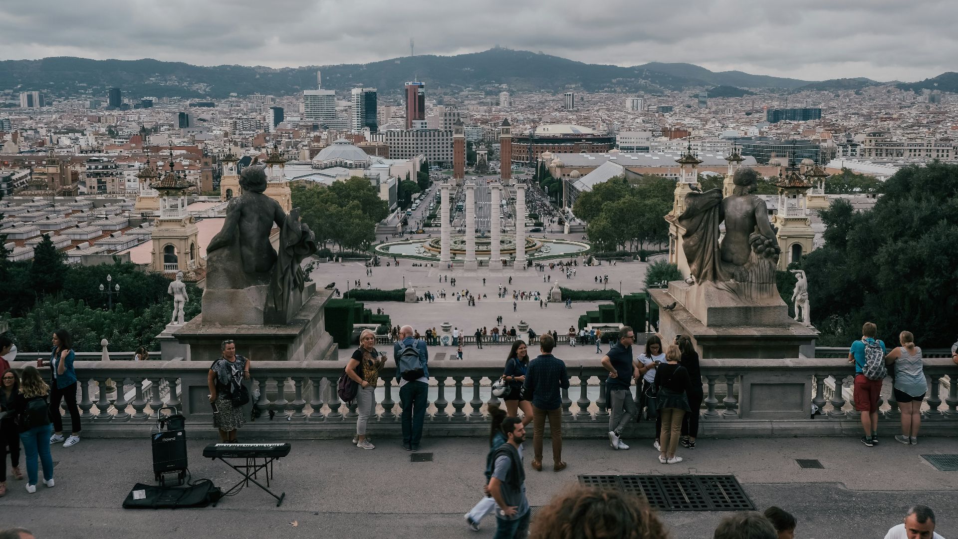 people standing on terrace overlooking cityscape