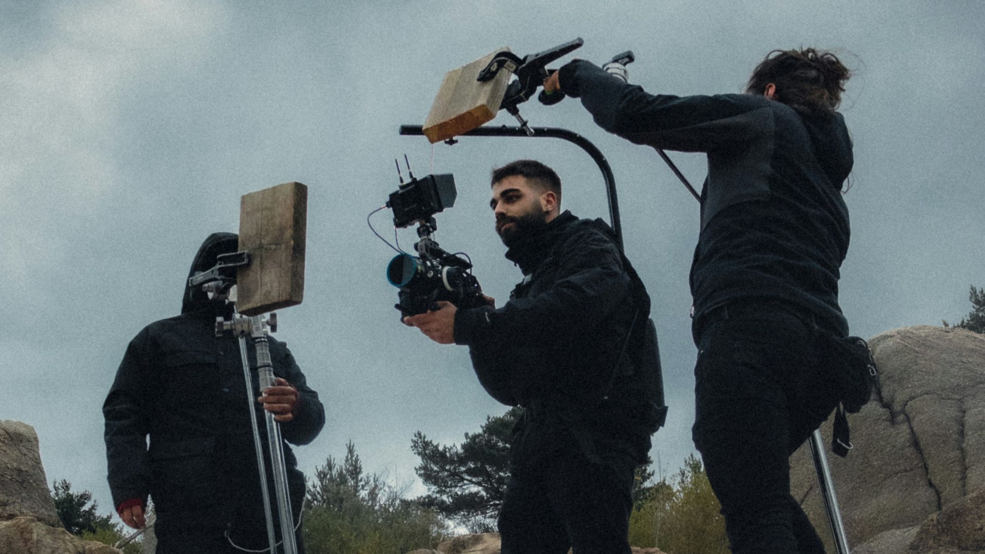 a group of people standing on top of a rocky hillside