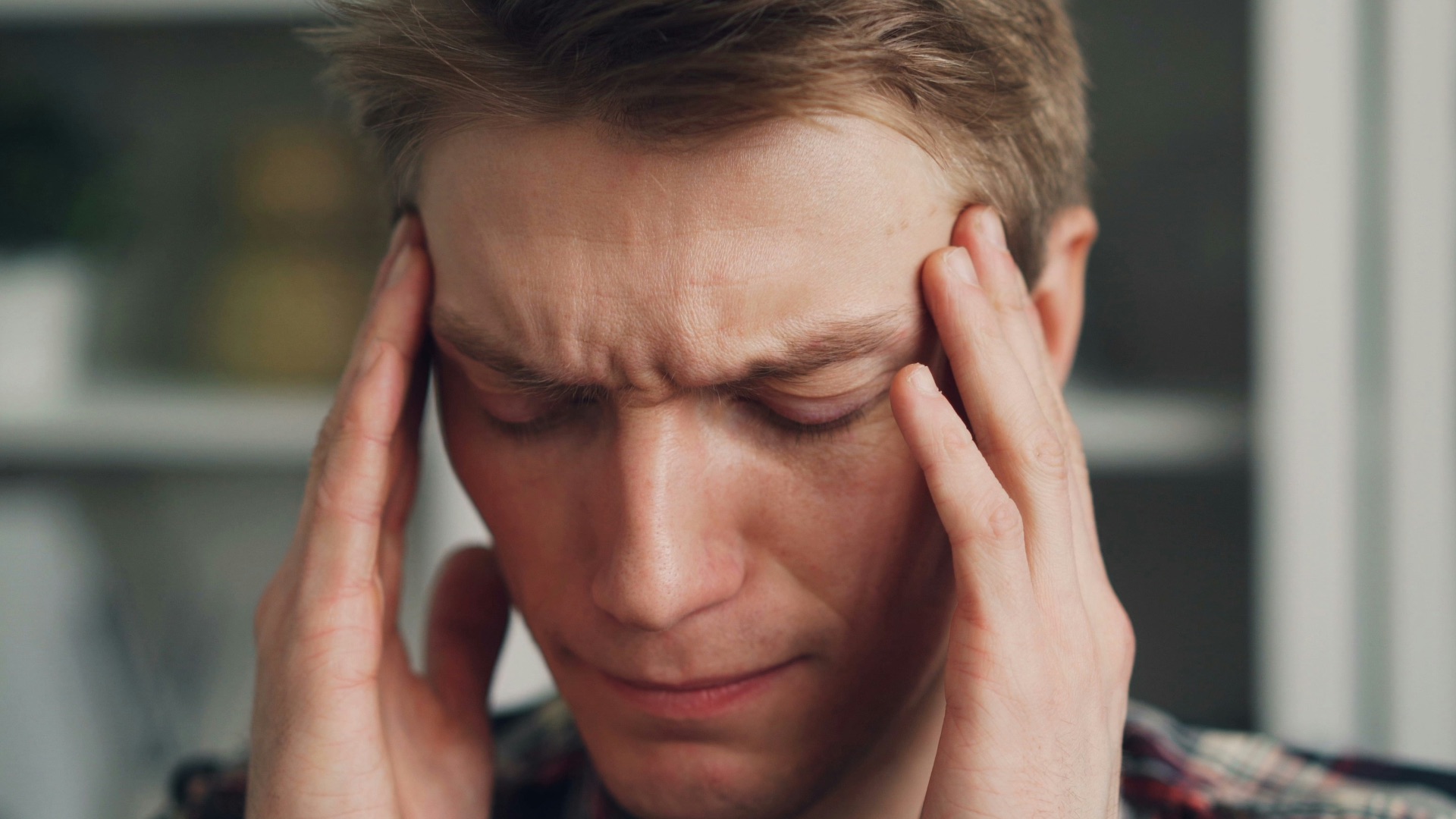 a man holding his hands to his ears