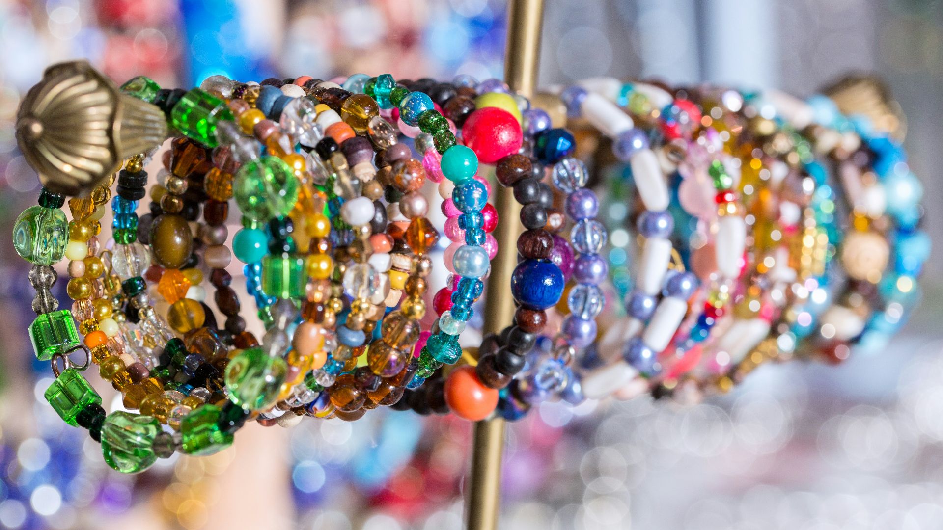 A bunch of bracelets that are on a stick