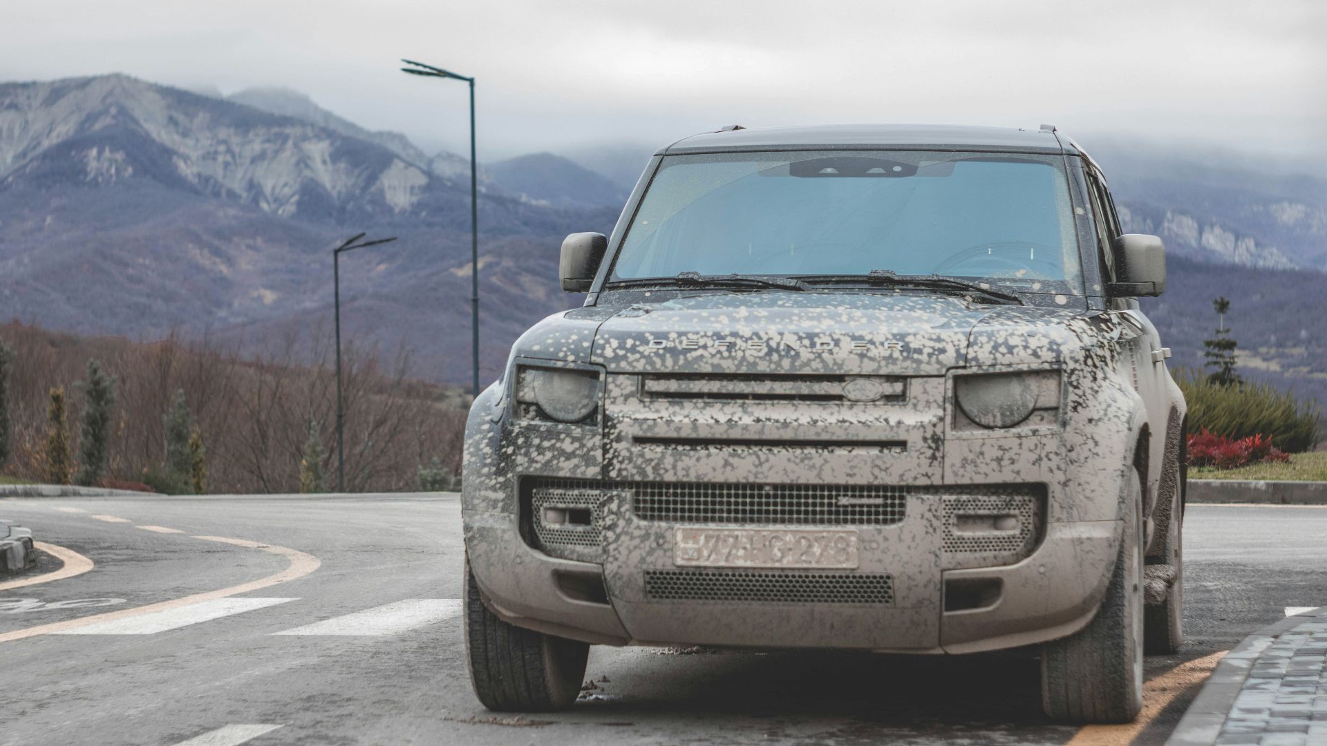 a silver truck parked on the side of a road
