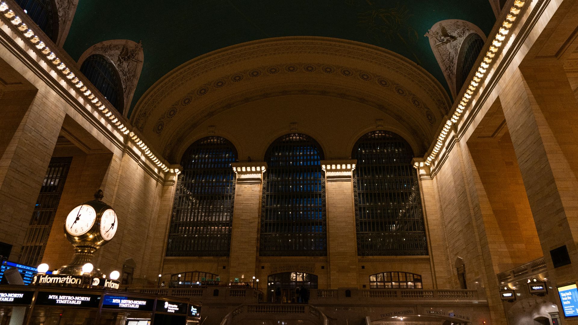 a train station with a lot of lights on the ceiling