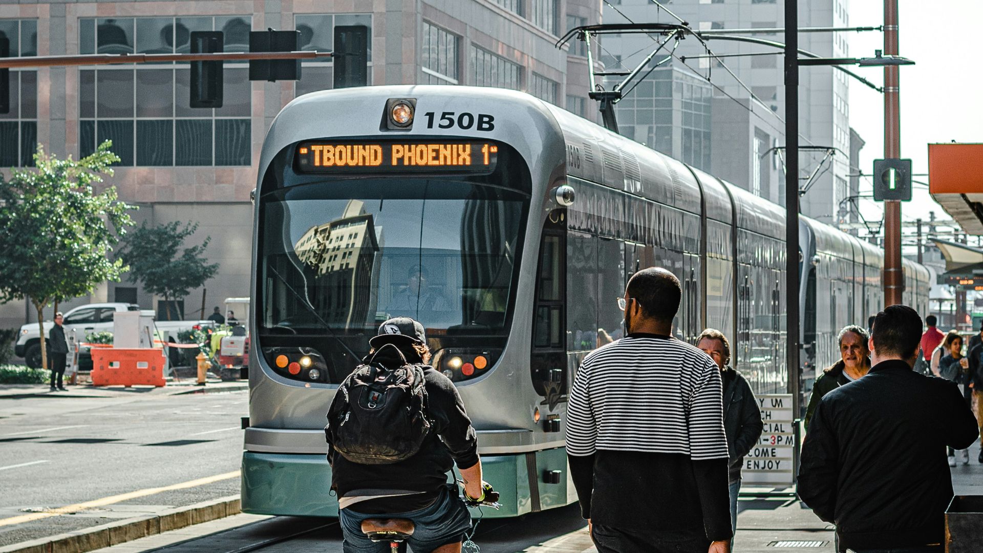 people walking on pedestrian lane near white and red train during daytime