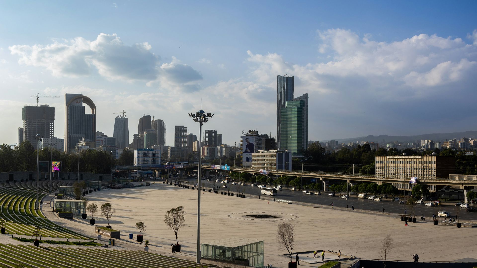 a large empty stadium with a city in the background