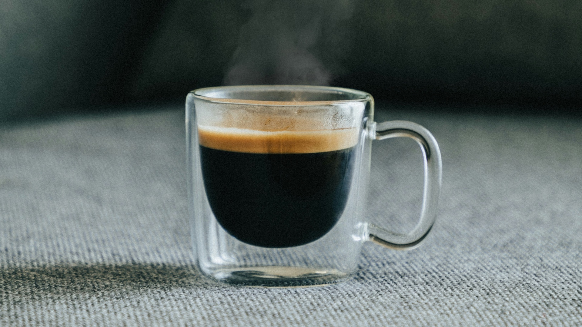 clear glass mug with brown liquid