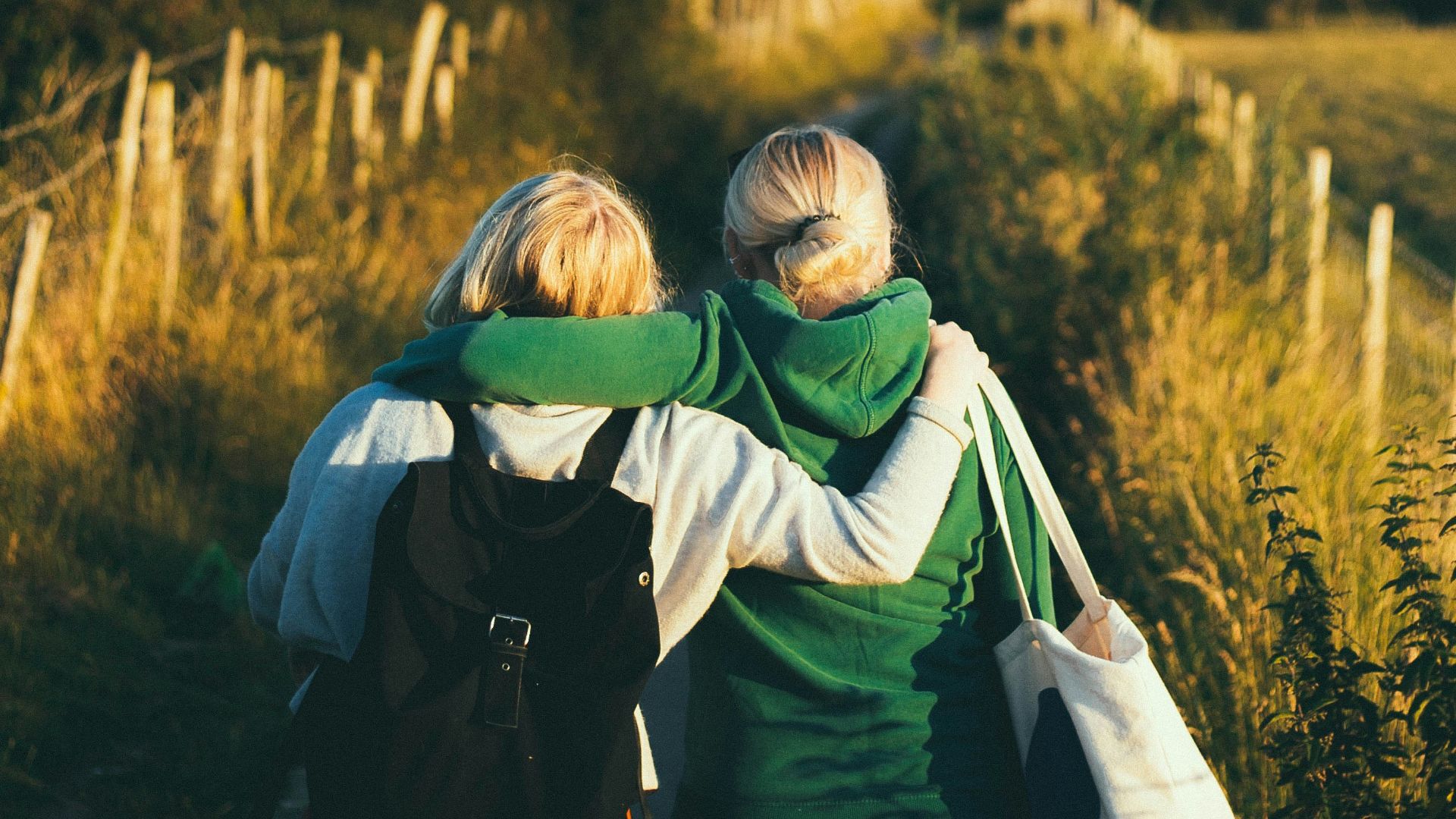 two women walking together outdoor during daytime