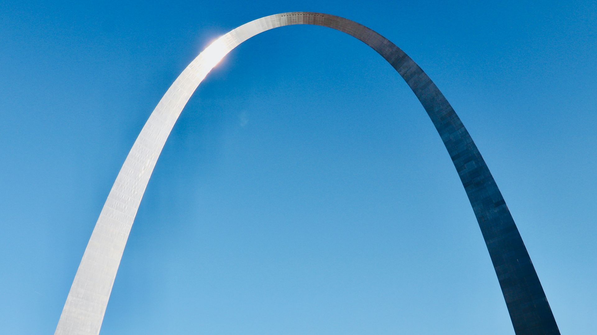 a very tall arch towering over a city