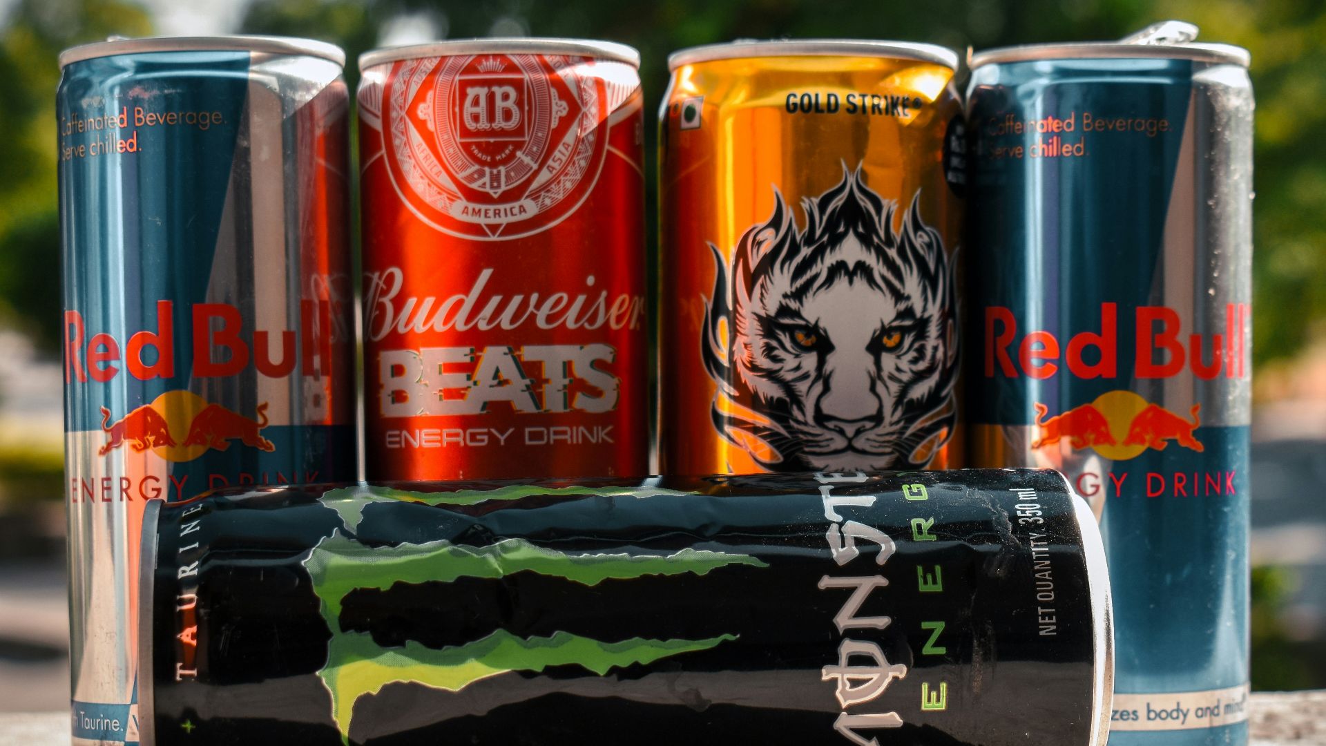 a group of four cans of soda sitting next to each other