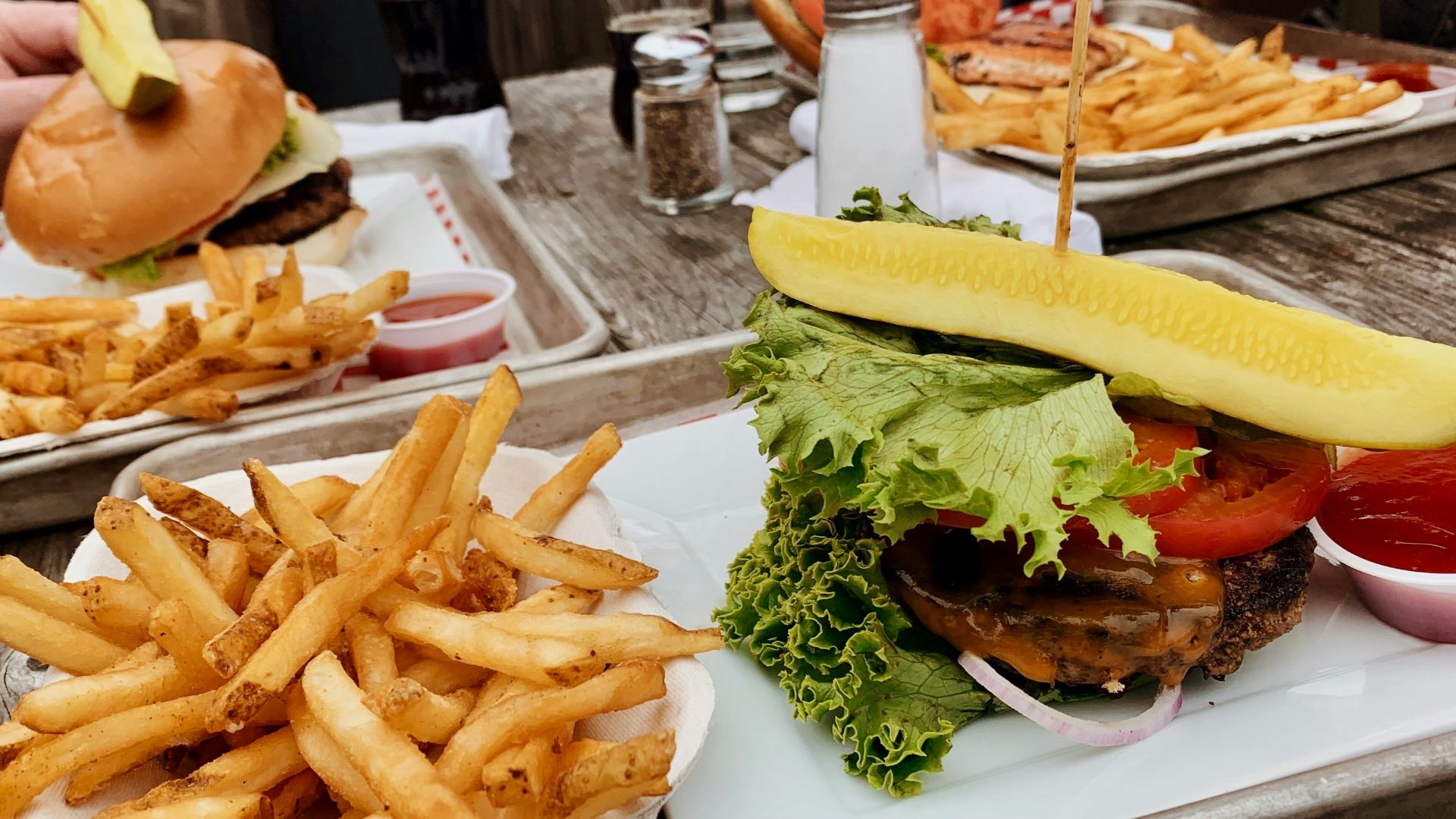 potato fries near burger with cabbage beside ketchup