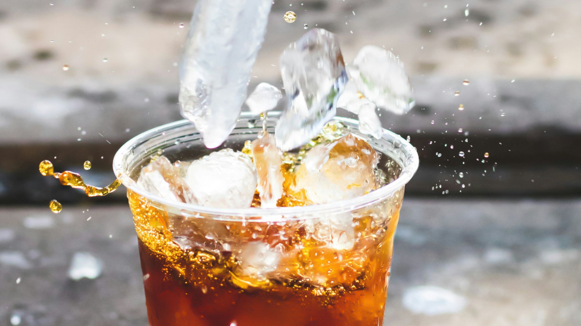 macro photography of dropping ice cube in cup