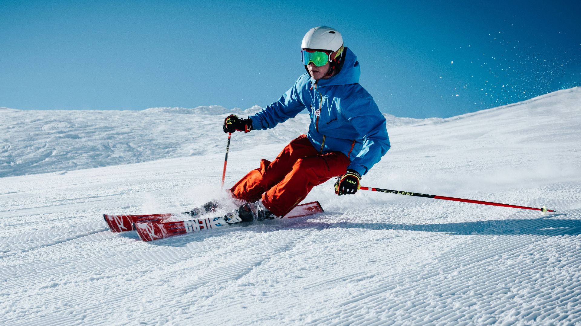man ice skiing on hill