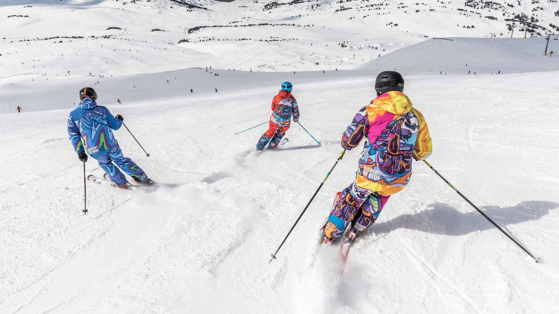 2 person in yellow jacket and blue helmet riding ski blades on snow covered mountain during