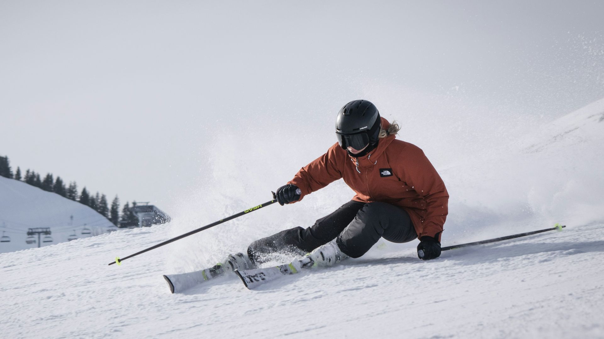 person in red jacket and black pants riding on snow board during daytime
