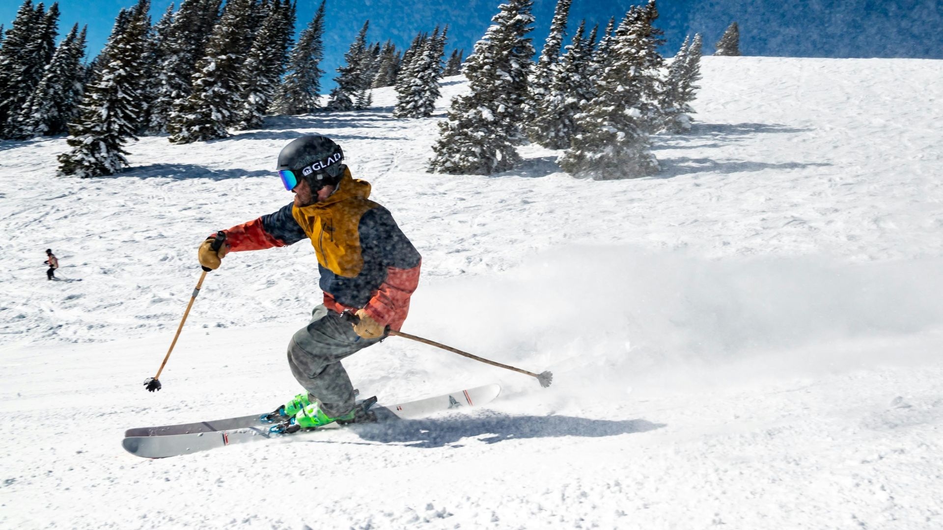 person in red jacket and blue pants riding on ski blades on snow covered ground during