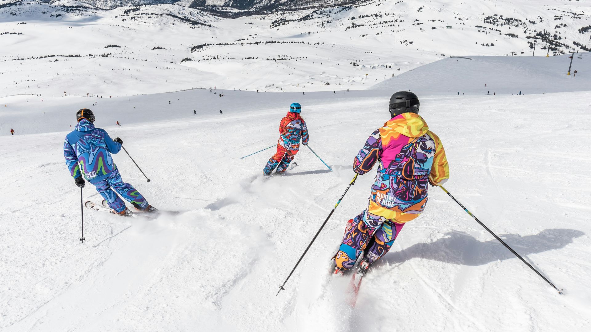 2 person in yellow jacket and blue helmet riding ski blades on snow covered mountain during