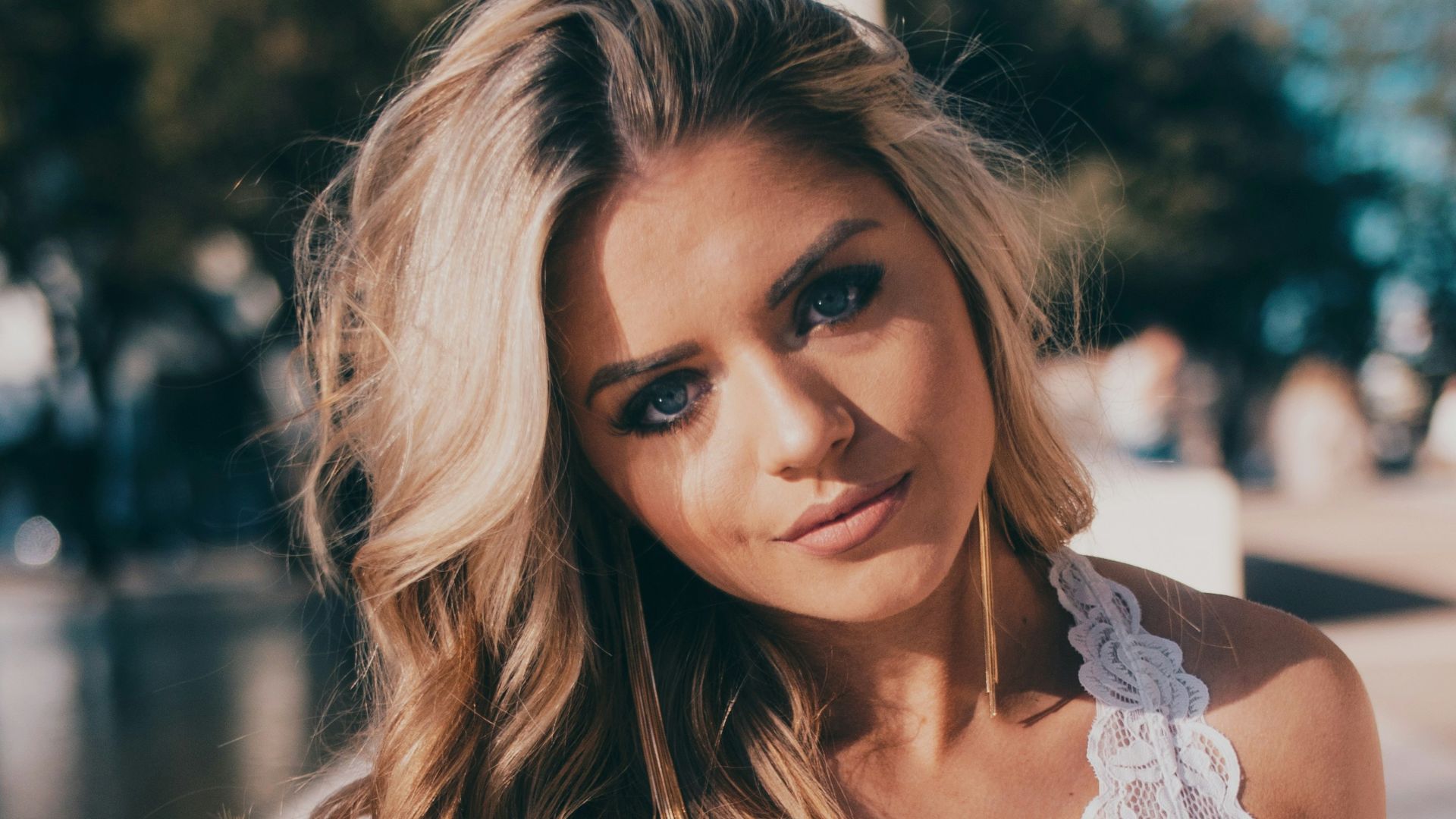 woman wearing lace halter top and blue denim jeans