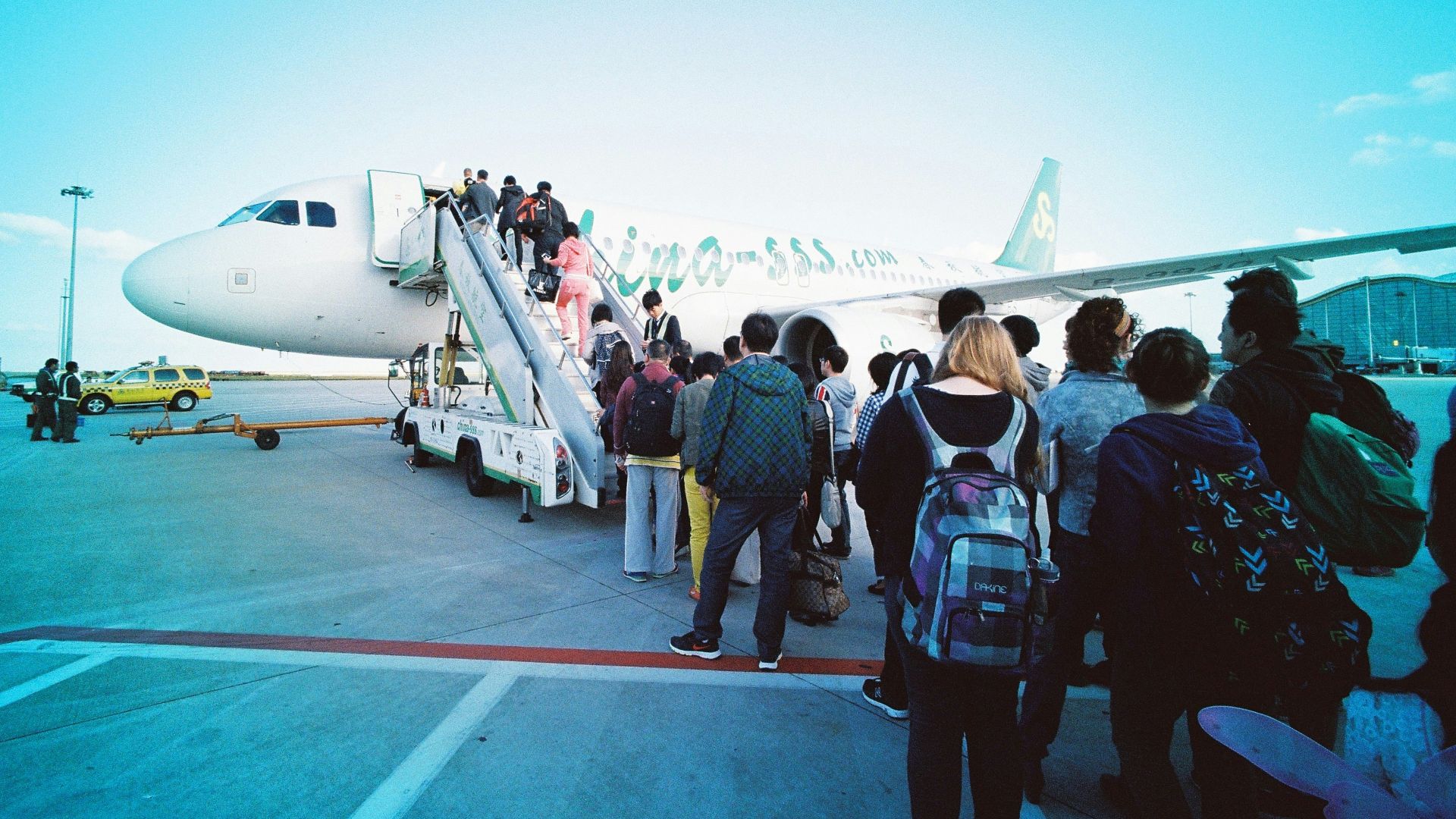 people about to enter plane during daytime