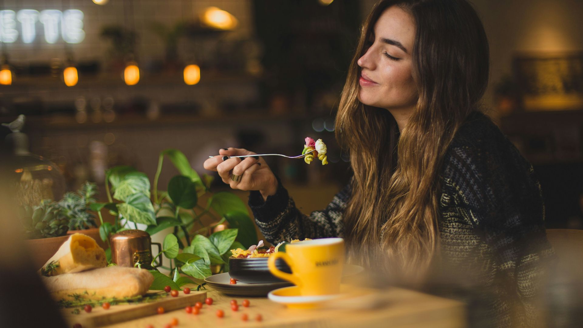woman holding fork in front table
